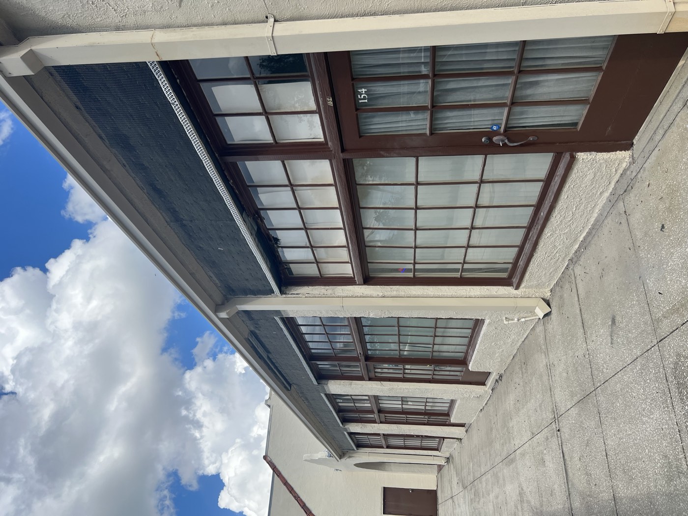 Fresh stucco base coat along the whole storefront