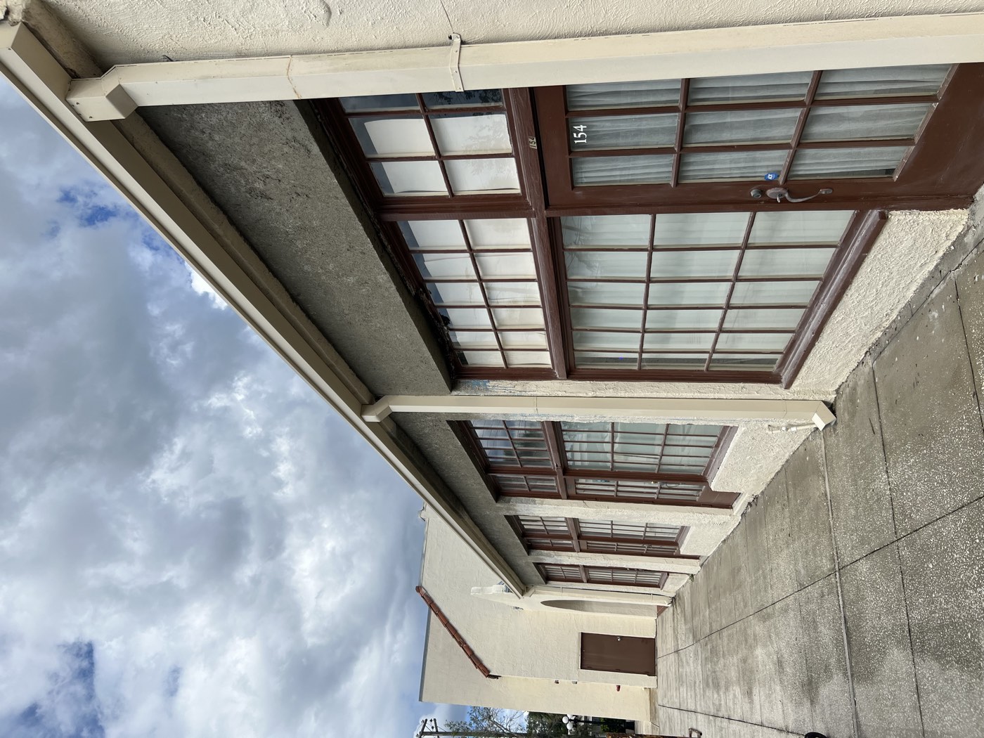 The finished storefront with a solid new stucco band