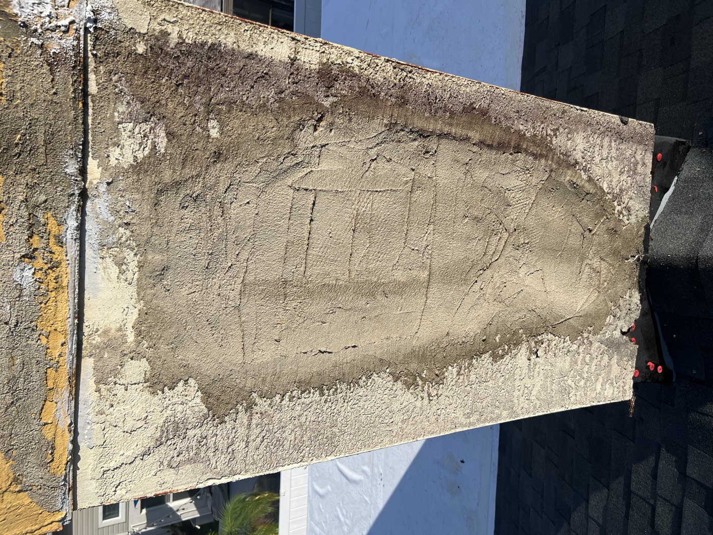The chimney with loose stucco removed down to a sound base