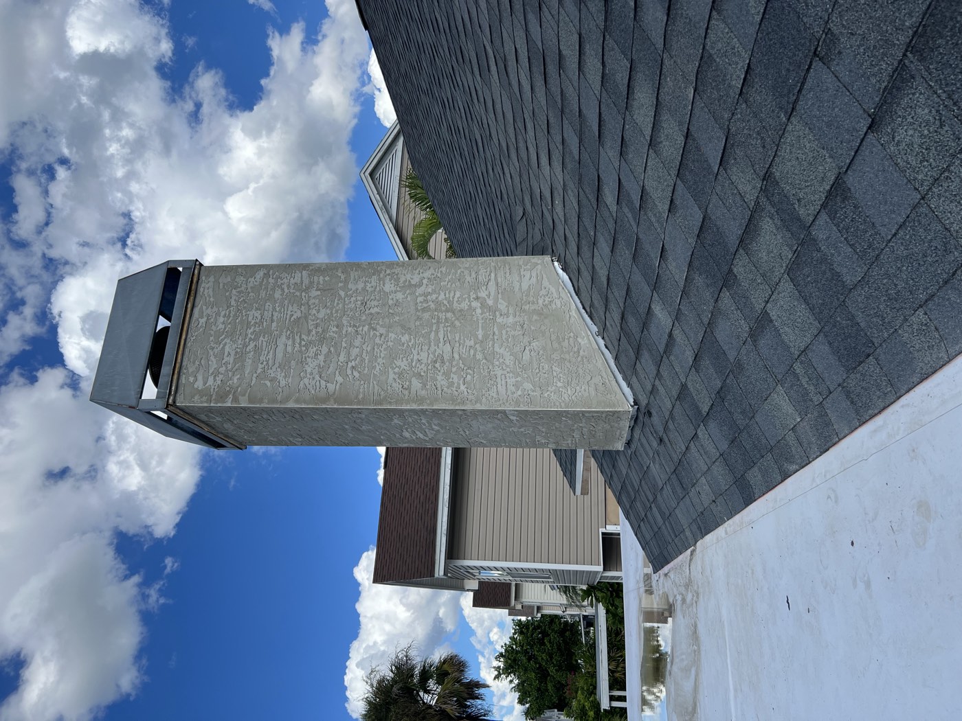The finished chimney with a smooth new stucco finish