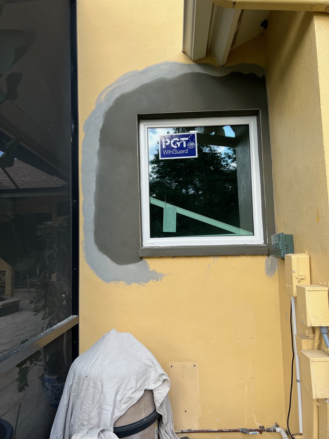 The window with a smooth new stucco surround